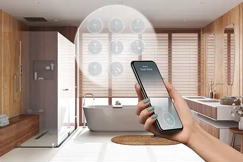 Golden Rule Handyman & Painting Service—a woman’s arm extends holding an iPhone to control her smart bathroom features in a home in Springfield, IL.