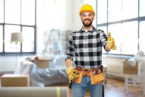 Golden Rule Handyman & Painting Service—A professional handyman with a toolbelt preparing to do services around the house to help the owners prepare for a home sale in Springfield, IL.
